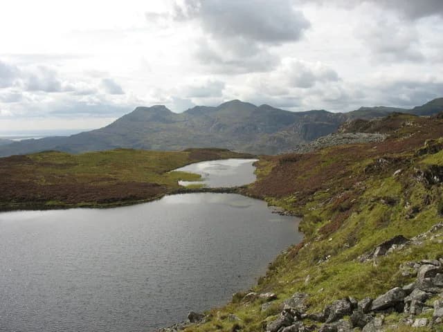 Upland lake (Llyn Dubach) in two connected basins, seen from above with the Moelwyn hills in the background, Snowdonia.