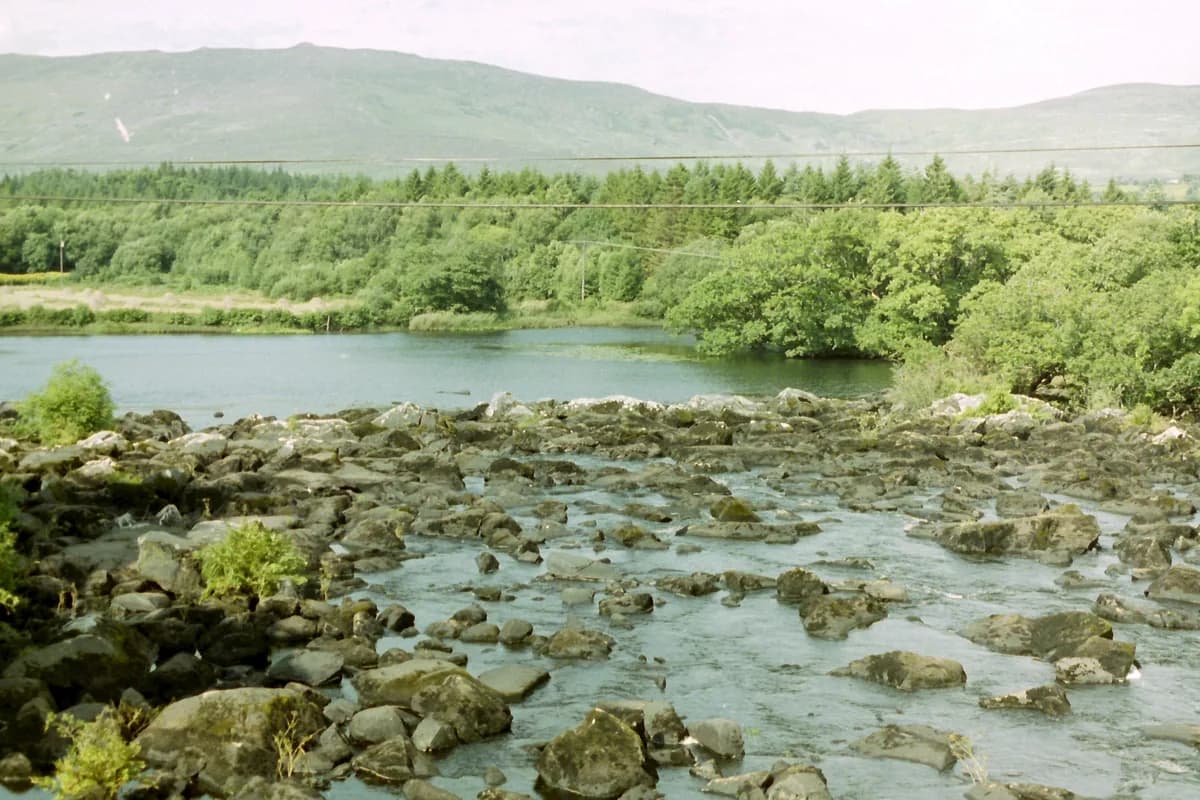 The Caragh River winding through a green valley on the Ring of Kerry, County Kerry, Ireland.