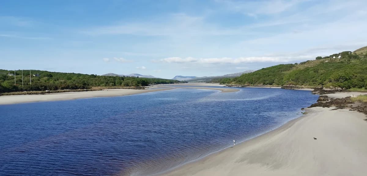 Wide view of the tidal Gweebarra River estuary with sandbars and hills in the distance, County Donegal, Ireland