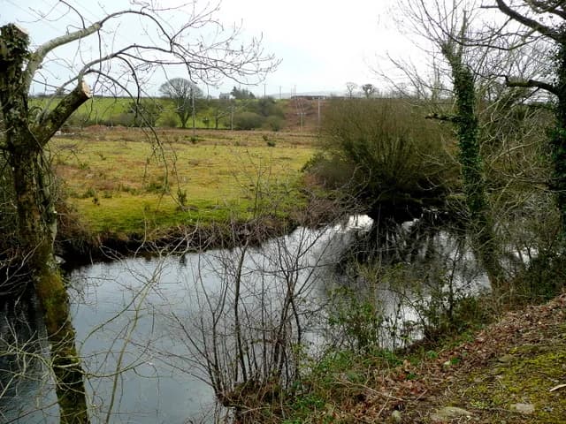 View across the River Seiont (Afon Seiont) near Caernarfon, with trees lining the banks.