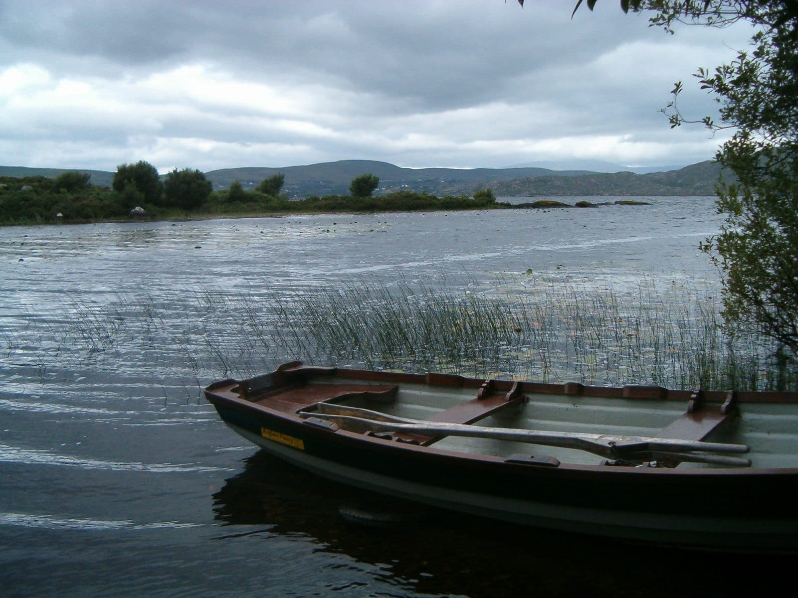 A fishing boat moored on the calm open water of Lough Currane near Waterville, County Kerry.